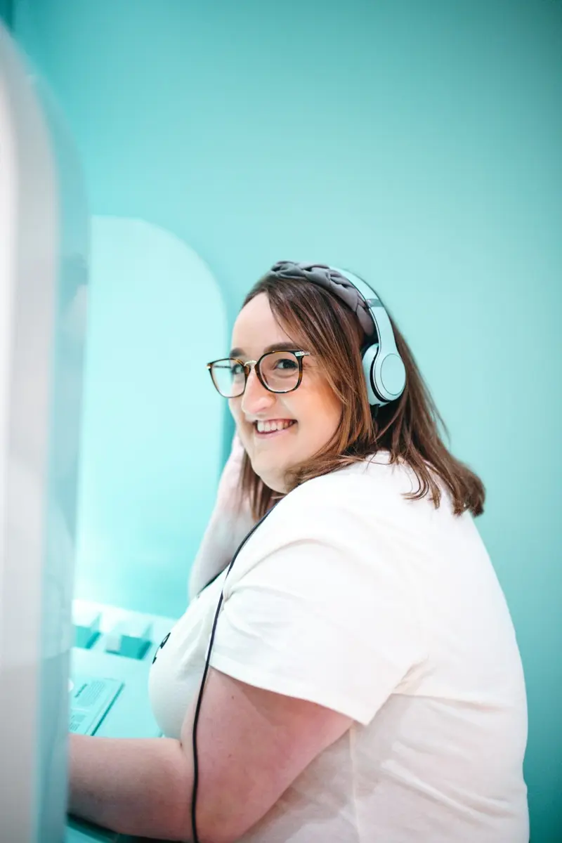 An employee in headphones practicing a customer call